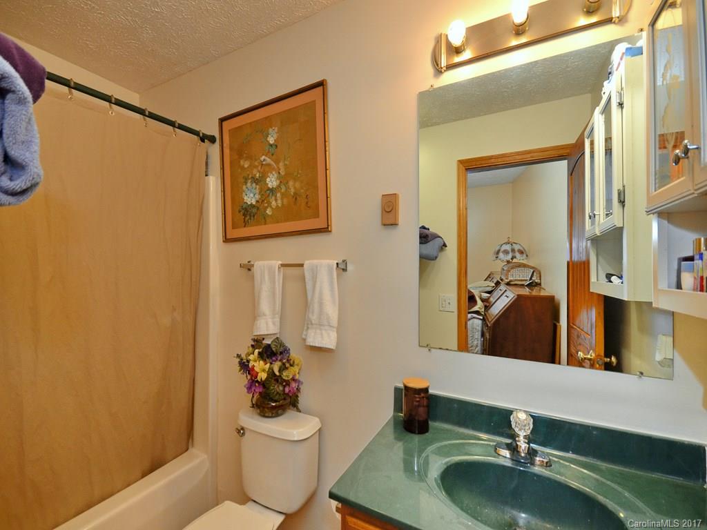 1010 Wesley Creek Road Clyde, NC 28721 - Photo 7 of 12 a bathroom with a sink mirror vanity and toilet