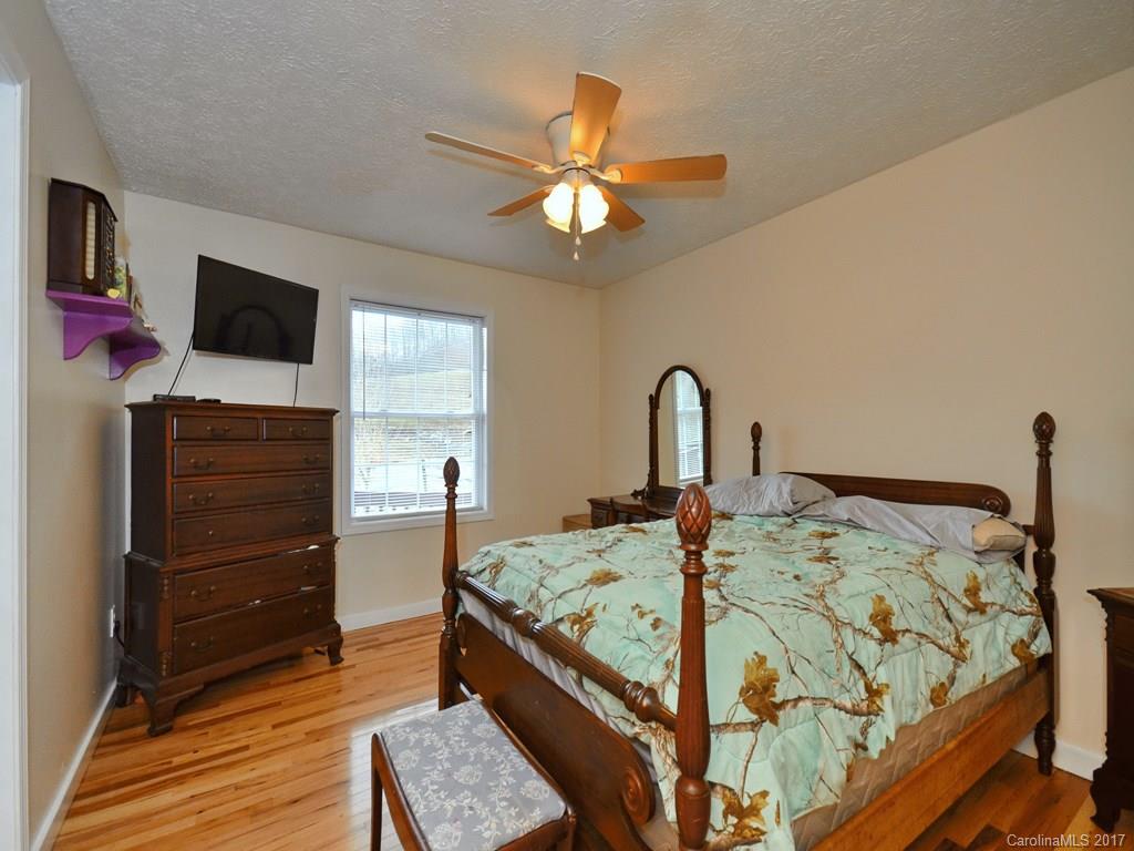 1010 Wesley Creek Road Clyde, NC 28721 - Photo 8 of 12 a bed room with a bed and a television