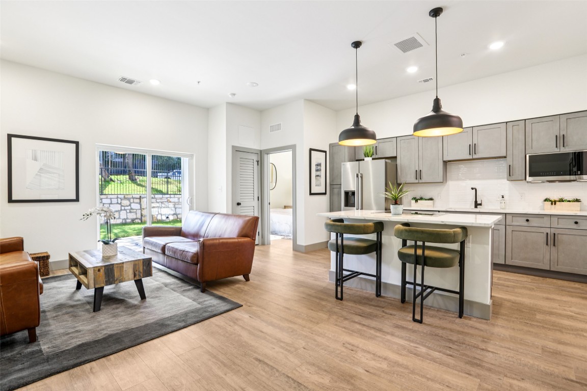 2450 Wickersham Lane, Unit 2023 Austin, TX 78741 - Photo 1 of 27 Living area with light wood-style flooring and recessed lighting