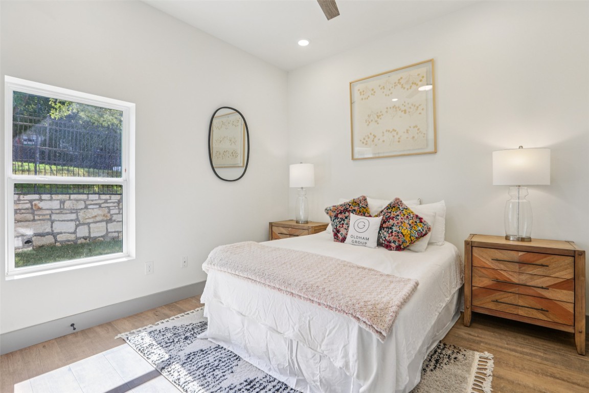 2450 Wickersham Lane, Unit 2023 Austin, TX 78741 - Photo 15 of 27 Bedroom featuring wood finished floors, ceiling fan, and recessed lighting