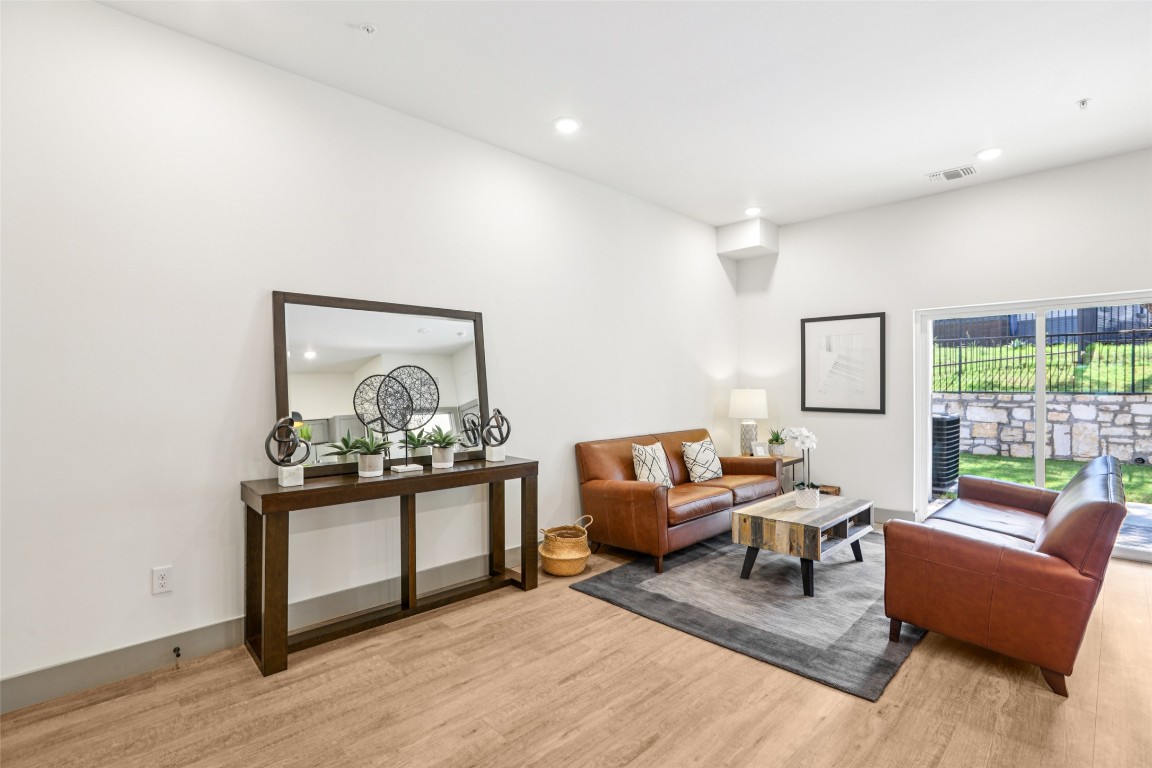 2450 Wickersham Lane, Unit 2023 Austin, TX 78741 - Photo 2 of 27 Living room with recessed lighting and light wood-style floors