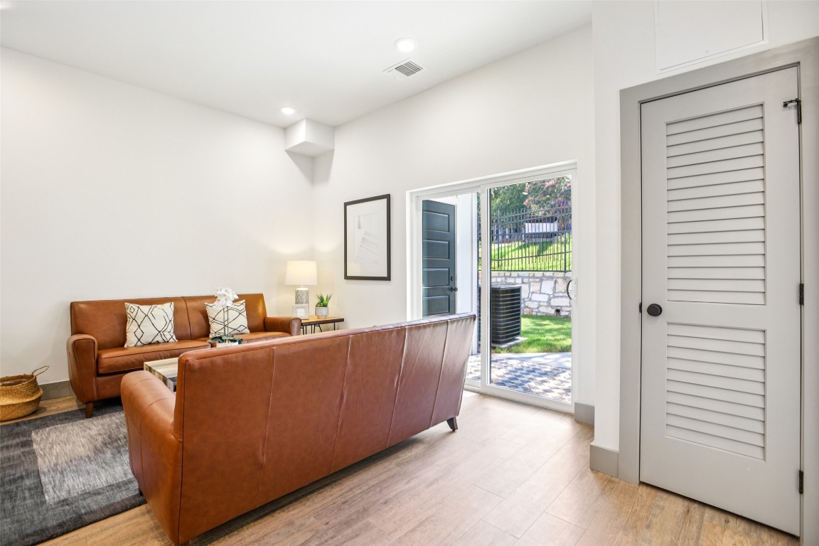 2450 Wickersham Lane, Unit 2023 Austin, TX 78741 - Photo 4 of 27 Living room featuring light wood-type flooring and recessed lighting