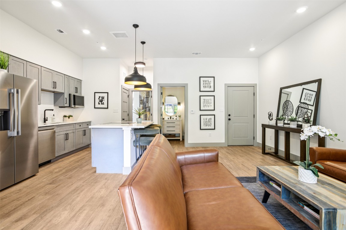 2450 Wickersham Lane, Unit 2023 Austin, TX 78741 - Photo 6 of 27 Living area with light wood finished floors and recessed lighting