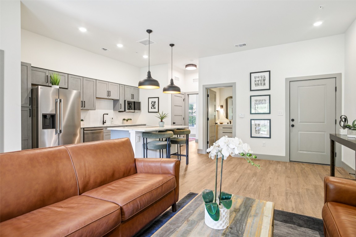 2450 Wickersham Lane, Unit 2023 Austin, TX 78741 - Photo 7 of 27 Living area featuring recessed lighting and light wood-type flooring