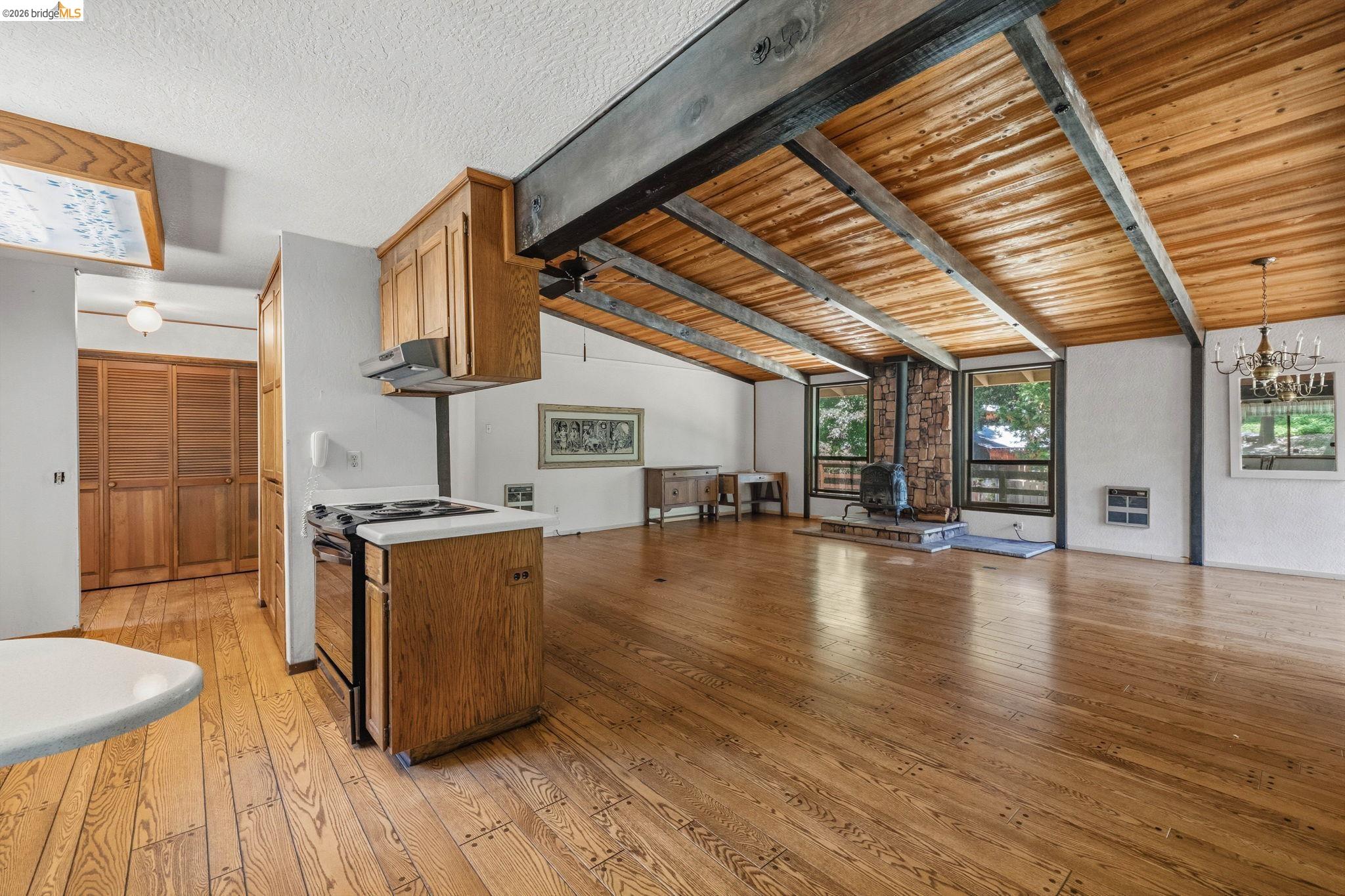 22401 South Fork Road Sonora, CA 95370 - Photo 14 of 34 Open-concept living area featuring wood-finish flooring, exposed wood beams, and a wood plank ceiling