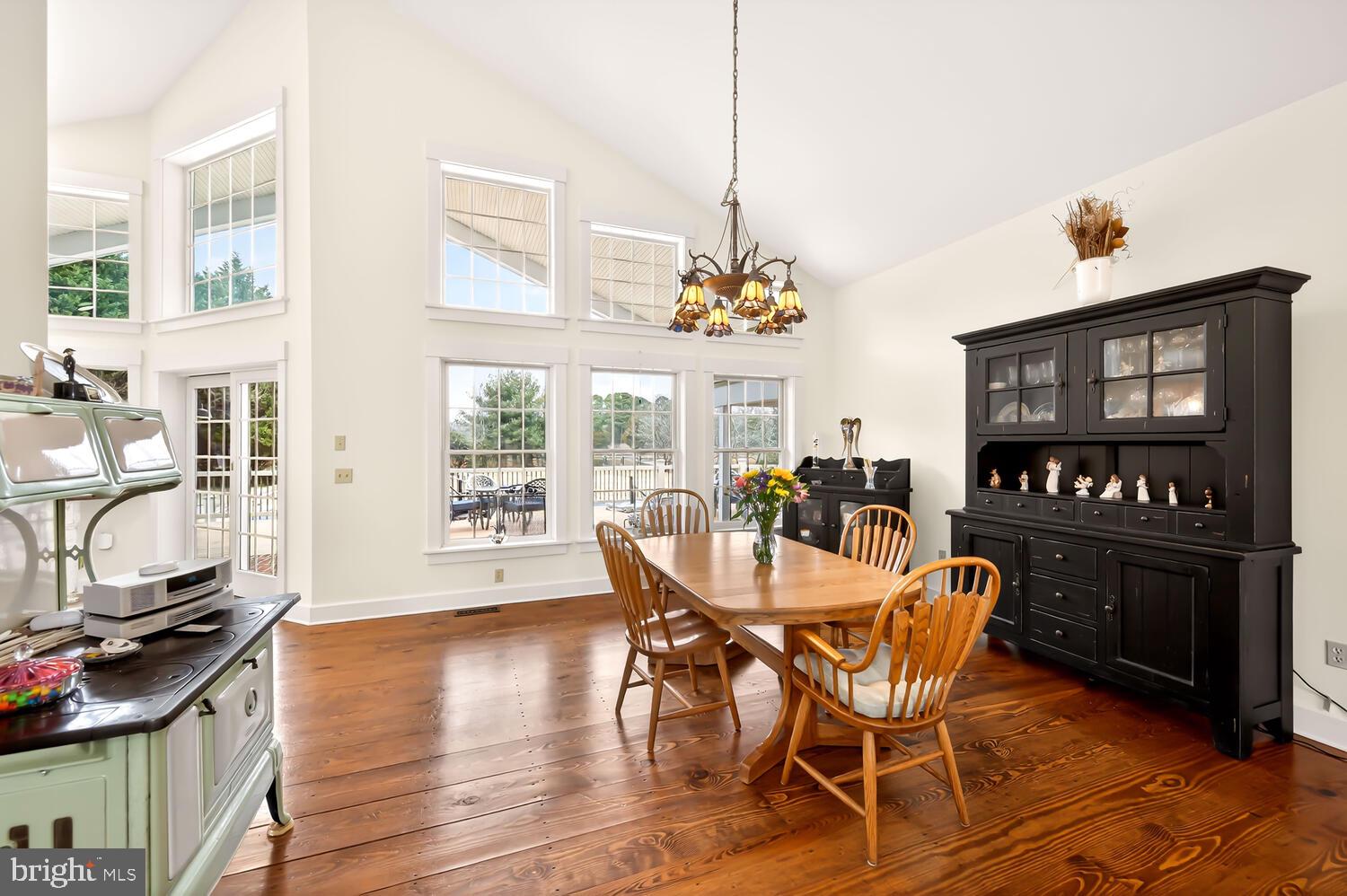 7605 Pendleton Farm Road Easton, MD 21601 - Photo 18 of 62 a dining room with furniture a chandelier and wooden floor