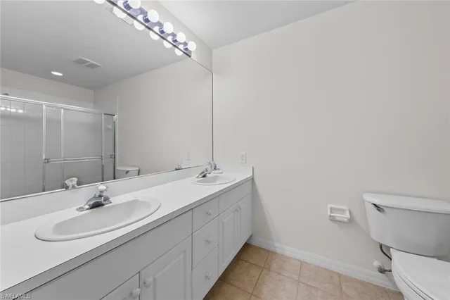 a bathroom with a sink double vanity and a toilet