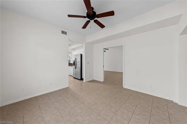 a view of empty room with ceiling fan