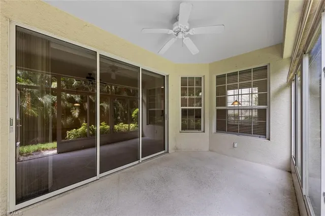 a view of an empty room with a glass door and a window