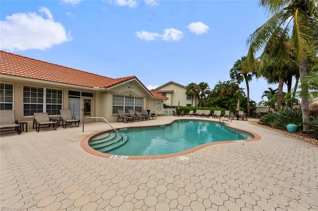 a view of a house with swimming pool and sitting area