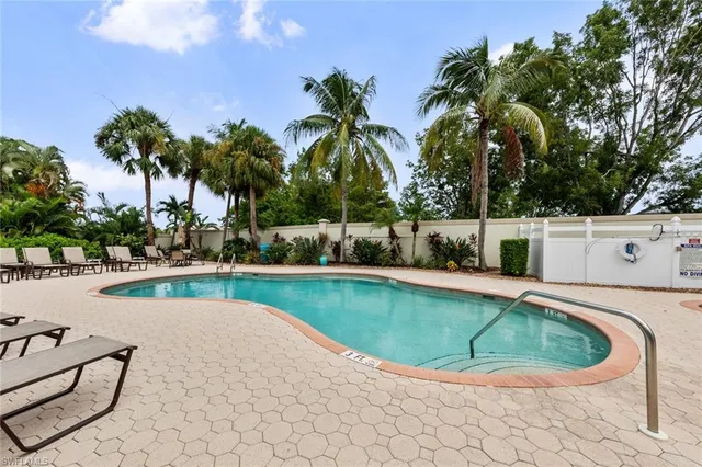a view of a swimming pool with a lounge chair
