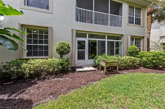 a view of a house with a yard and sitting area