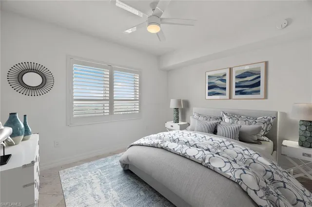 a bedroom with a large bed and a window