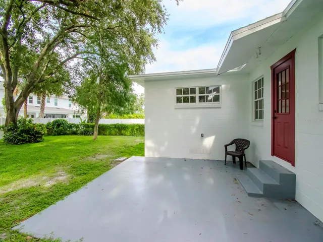 a view of a chair and table in the backyard