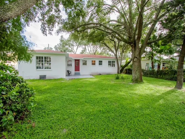 a view of house with yard and green space