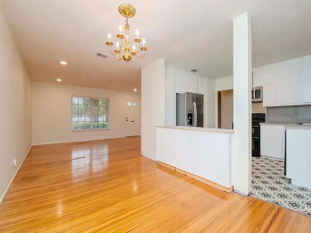 a view of livingroom and kitchen with hardwood floor