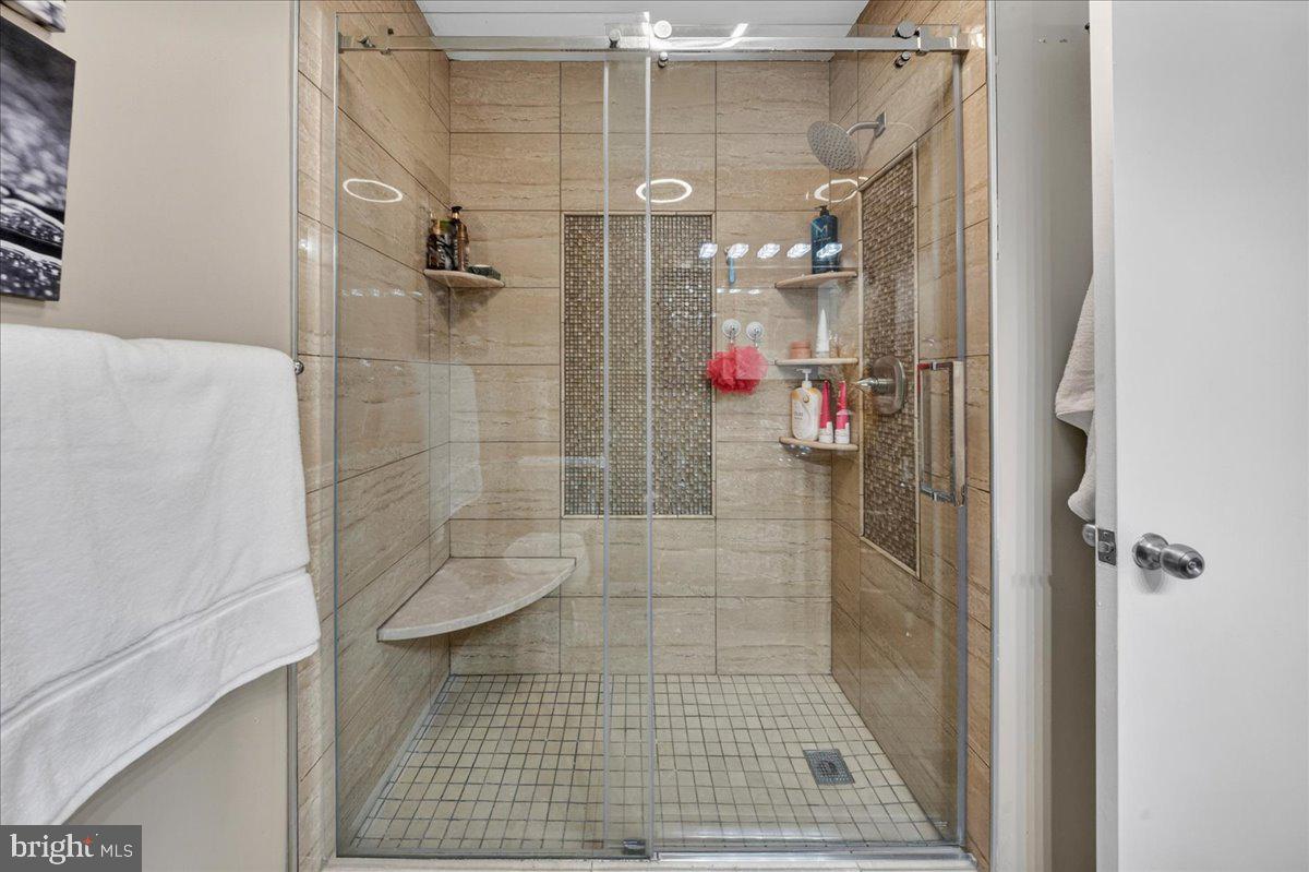 8930 Krewstown Road, Unit 310 Philadelphia, PA 19115 - Photo 14 of 32 a bathroom with a shower