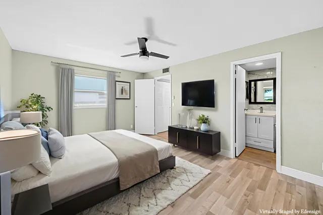 a bedroom with a bed dresser and mirror