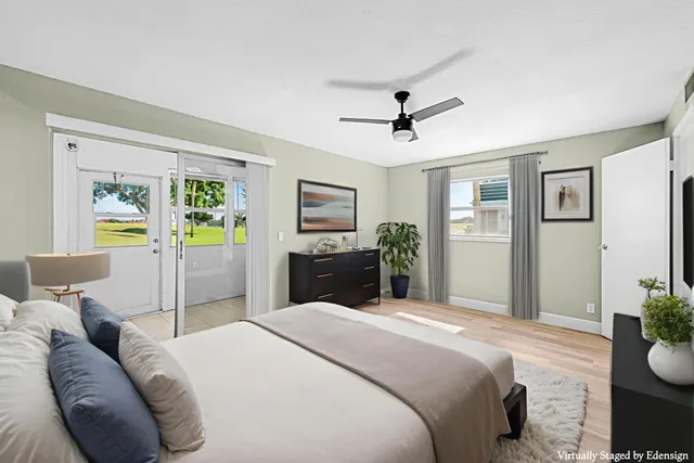 a view of empty room with wooden floor and ceiling fan