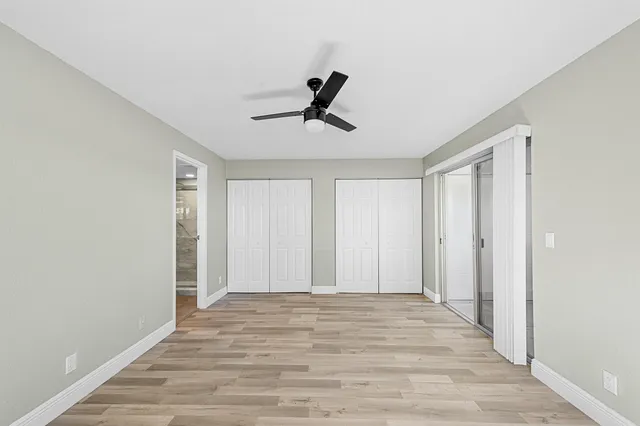 a bathroom with a toilet a sink a mirror and vanity