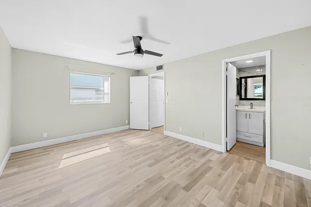 a view of a room that has a bed and a window