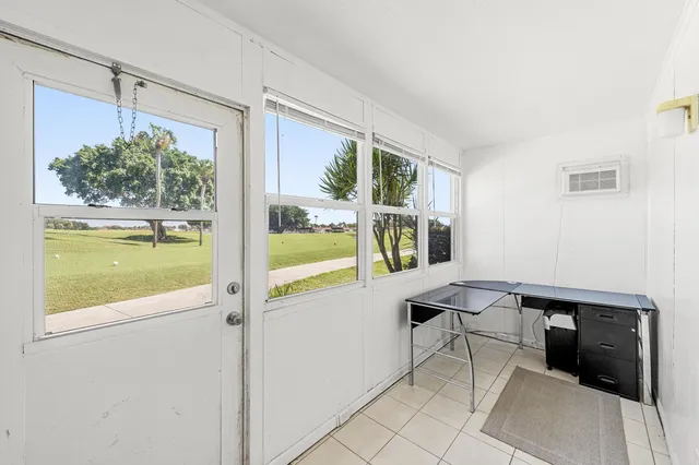 a view of a house with pool and sitting area