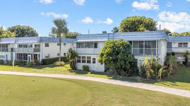 an aerial view of a residential houses with outdoor space