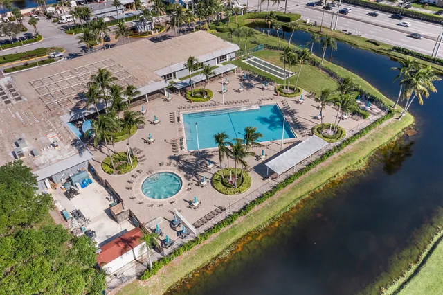 an aerial view of residential houses with outdoor space and river