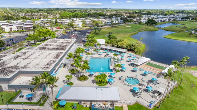 an aerial view of residential houses with outdoor space and swimming pool