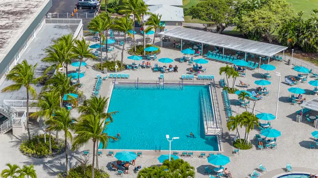 a room with pool table chairs and a chandelier