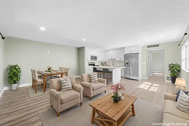 a living room with furniture a dining table and chairs
