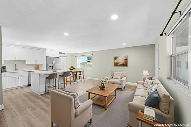 a view of kitchen with wooden floor and electronic appliances