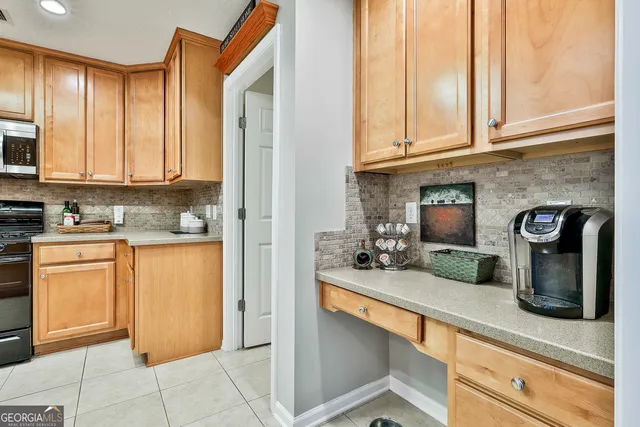 a kitchen with stainless steel appliances granite countertop a sink and cabinets