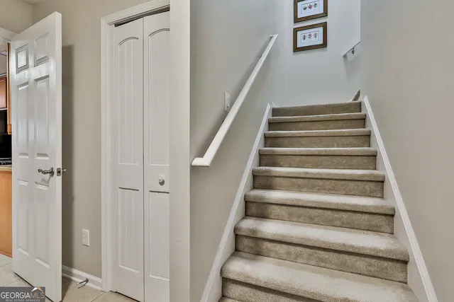 a spacious bedroom with a bed and a chandelier