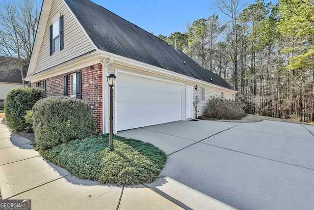 a patio with a table and chairs and potted plants