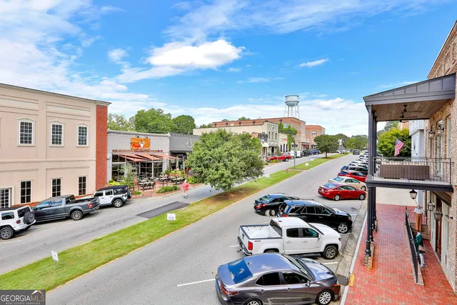 a view of a patio with chairs and potted plants