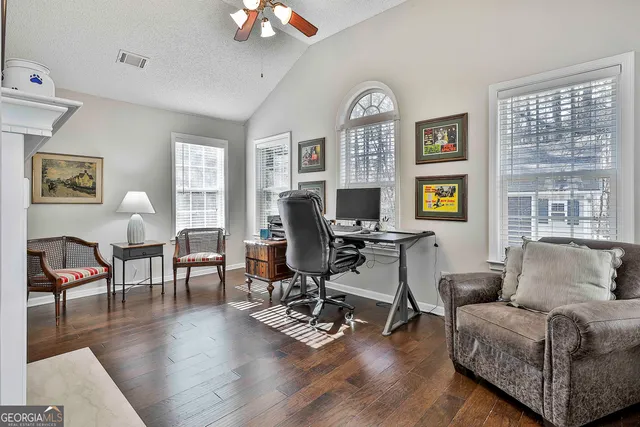 a living room with furniture a dining table and a window