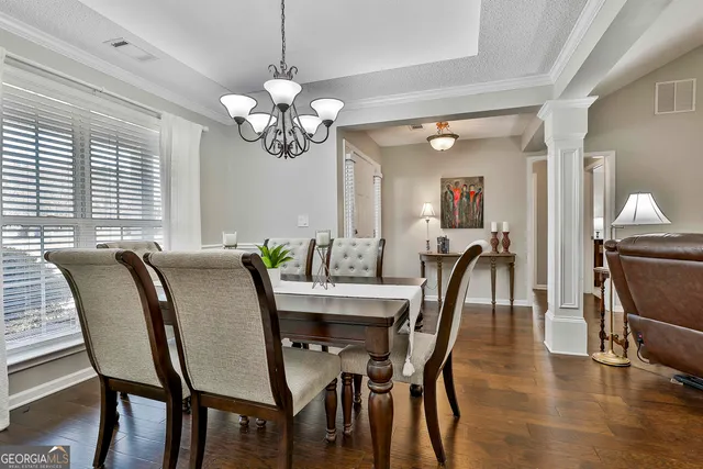 a view of a dining room with furniture window and wooden floor
