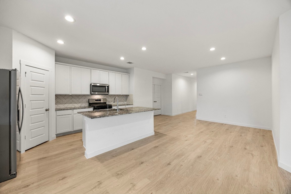 2732 Misty Elm Lane Rosenberg, TX 77469 - Photo 13 of 30 a kitchen with a refrigerator and white cabinets