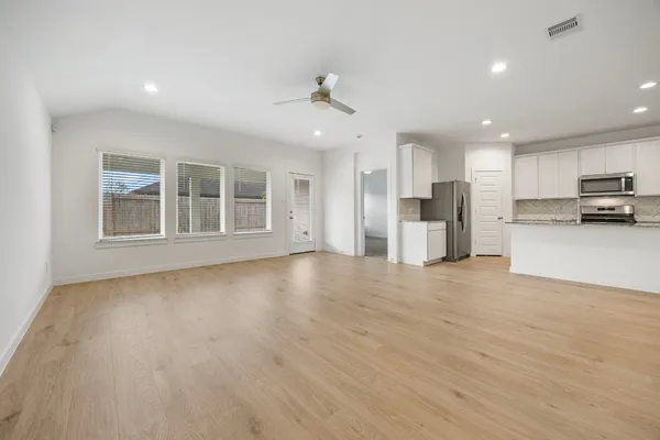 a view of a kitchen with a sink and a refrigerator