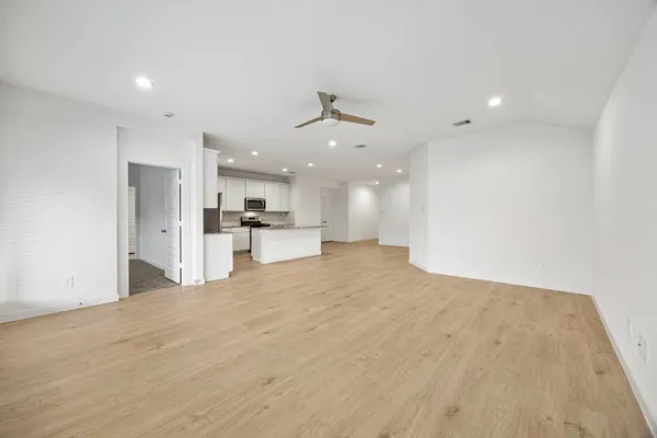 a view of a kitchen with a refrigerator and a sink