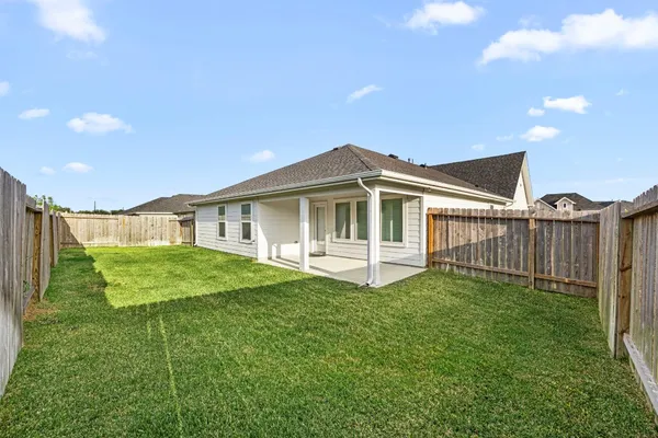 a white house that has tree in front of it