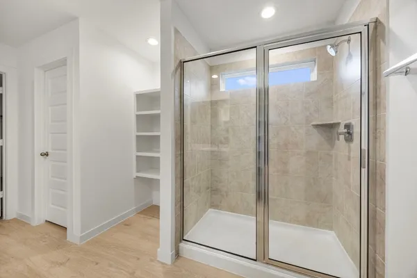 a bathroom with a glass shower door
