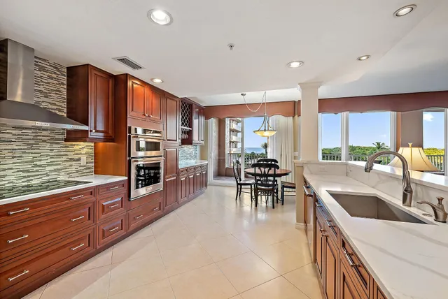 a kitchen with lots of counter top space and chairs