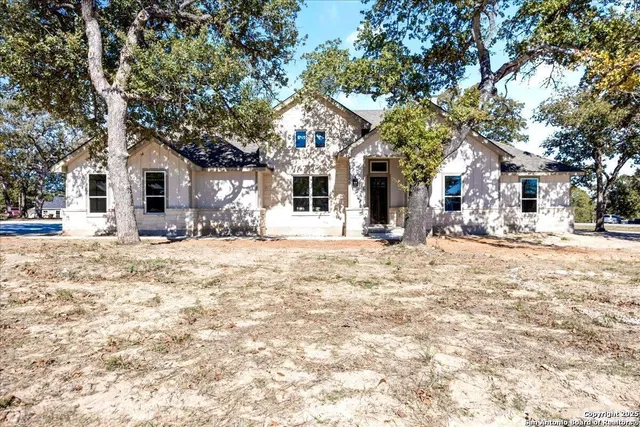a front view of a house with a yard covered in snow