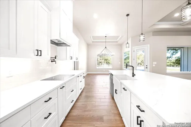 a view of a room with wooden floor and a window