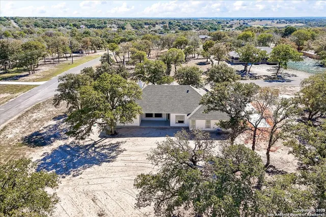 an aerial view of residential houses with outdoor space