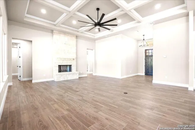 a kitchen with stainless steel appliances sink stove and white cabinets with wooden floor