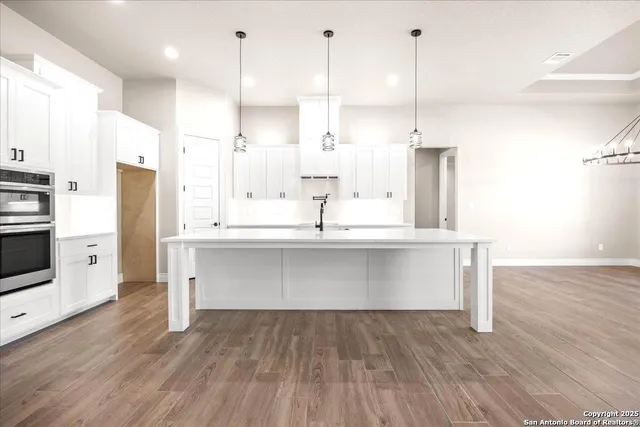 a bathroom with a bathtub sink and mirror