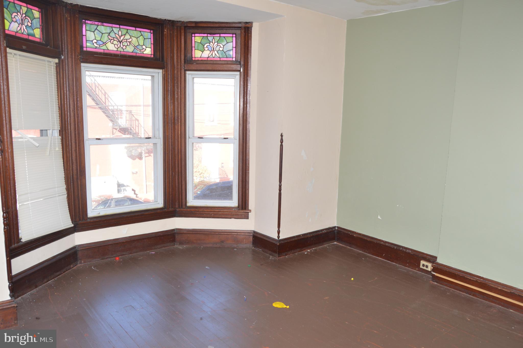 802 Chestnut Street Reading, PA 19602 - Photo 16 of 38 Primary Bedroom with bay window and stained glass